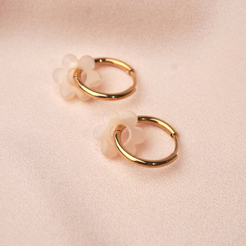 Small stainless steel hoop earrings with white flower