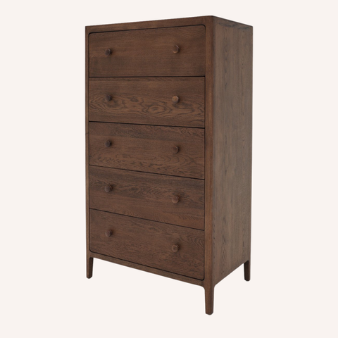 A tall, five-drawer wooden chest of drawers in a medium-to-dark brown finish, featuring small round knobs and tapered legs, shown against a plain off-white background.