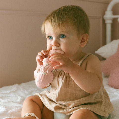 Baby holding Maeve the Mermaid teether