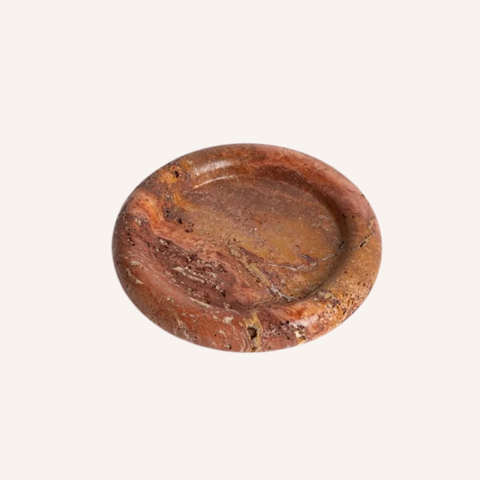 A round stone ashtray with a textured, marbled pattern in earthy brown, rust, and orange tones, shown on a solid off-white background.