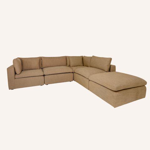 A beige fabric sectional sofa with a right-facing chaise lounge, shown against a plain off-white background.