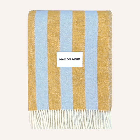 Blue Honey Blanket folded flat showing jacquard stripe pattern