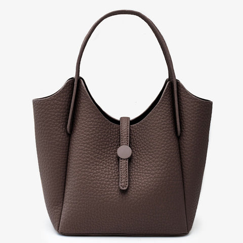 A dark brown pebbled leather handbag with a single top handle and a front strap closure with a round button, shown against a plain white background.