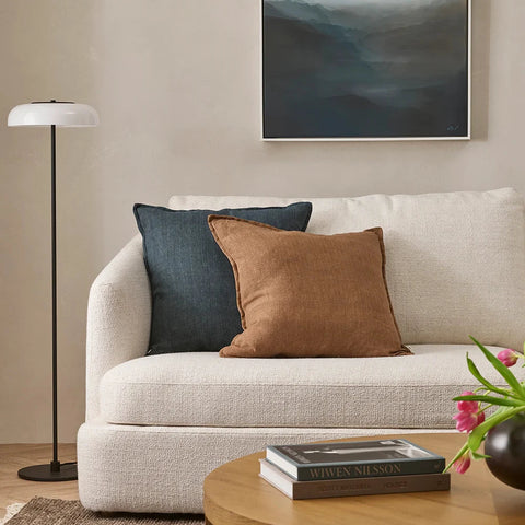 Cassia Chestnut handwoven 100% linen cushion with flange edge, styled on a sofa