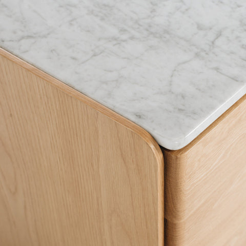 Close-up of Carrara marble top and push-open drawer on the Betty bedside table