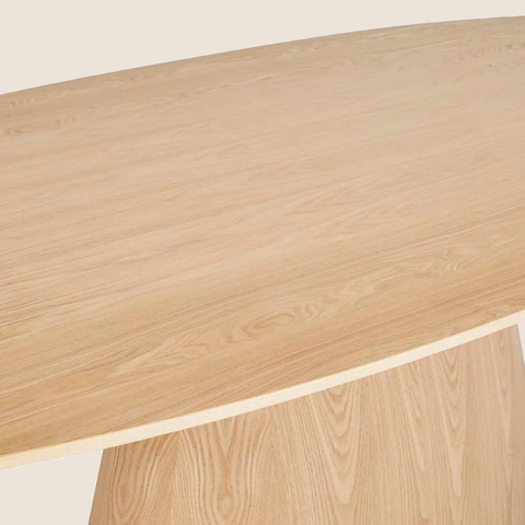 Close-up of natural ash veneer grain and curved top on the Matthew dining table