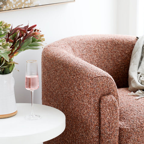 Close-up of rust boucle fabric texture on the Ember Chair
