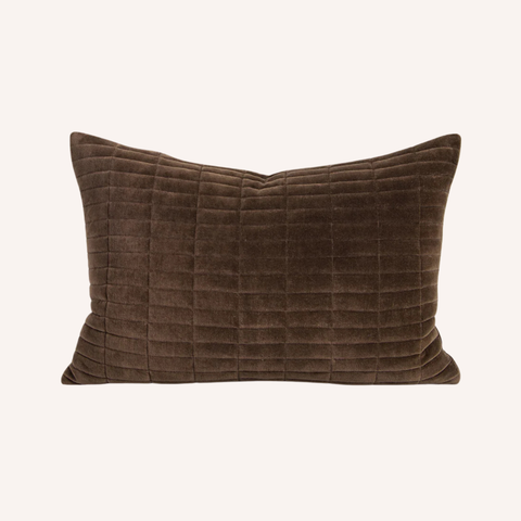 Close-up of the Tia lumbar cushion's quilted velvet surface and chocolate tone