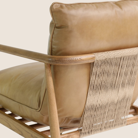Close-up of woven cord detail and tan leather cushion on the Solara lounge chair