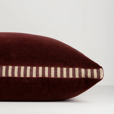 Side profile of Edward Oxblood Cushion showing striped linen gusset detail