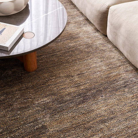 Fairbanks Fossil Rug in earthy brown tones styled in a living room setting