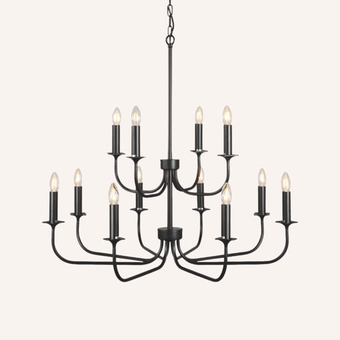 A 12-light black metal chandelier with candle-style bulbs, suspended against a solid off-white background.