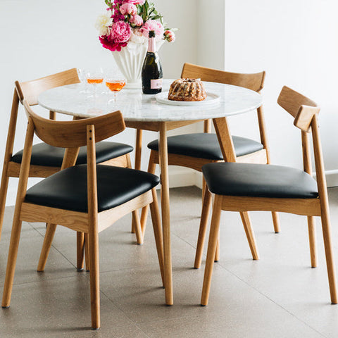 Freddie Scandinavian hardwood dining chair with PU leather seat, styled in a dining room
