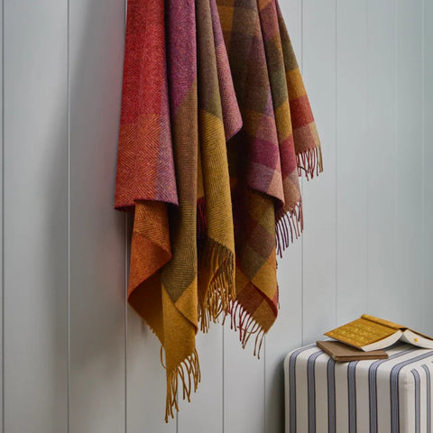 Harlequin Autumn NZ Wool Throw hanging from wall hooks
