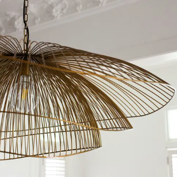 Havana Layered Pendant styled in a room setting, antique brass finish