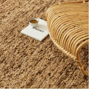 Henley Rug in natural wool, styled in a room setting