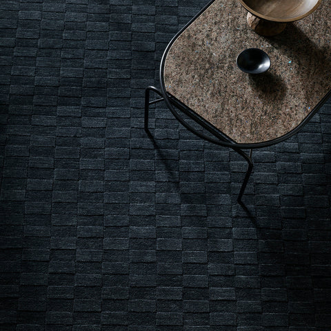 Hugo Midnight rug close-up showing hand-carved checkerboard pile depth