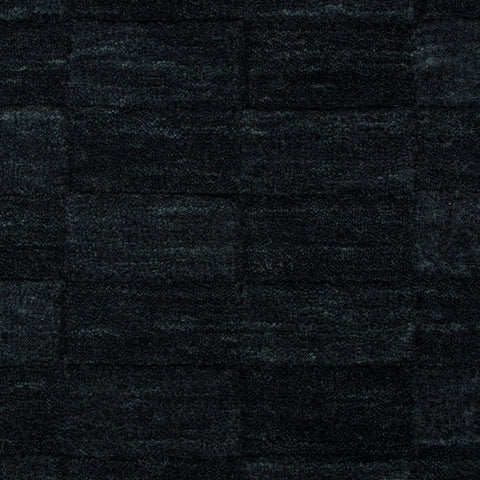 Hugo Midnight rug corner detail showing deep tone and wool texture