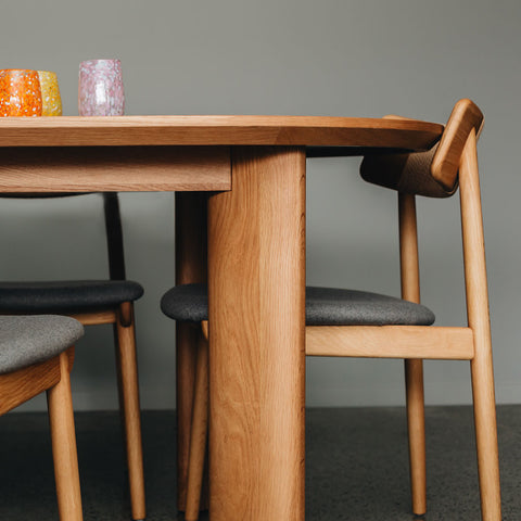 Johnny dining table styled in a dining room with chairs and table setting