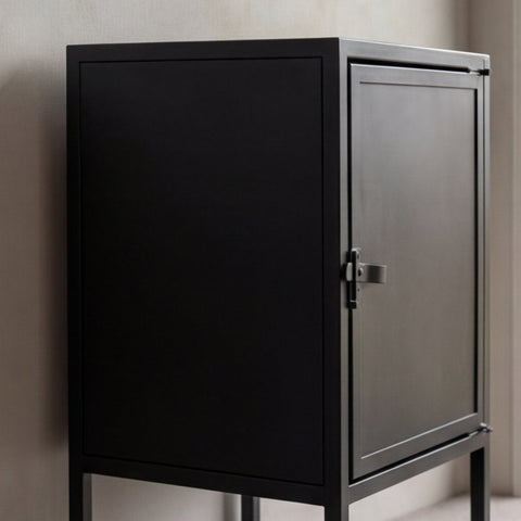 cabinet with black doors against a neutral wall.