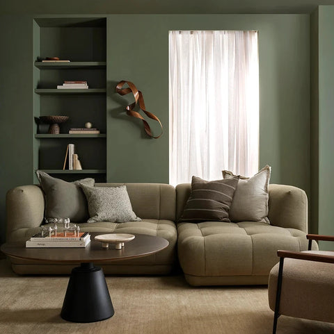 Linden Olive Cushion styled on a sofa