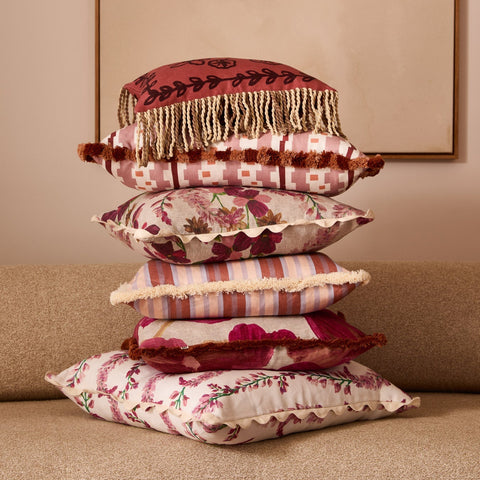 Lupin Multi Linen Cushion styled in a stack of pink and red toned cushions