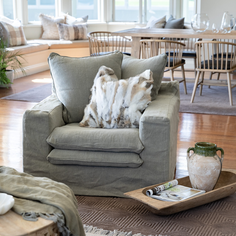 Luxury Lodge slipcover armchair in Cement, styled in a living room setting