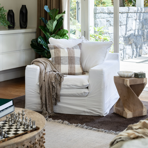 Luxury Lodge slipcover armchair in White, styled in a living room setting
