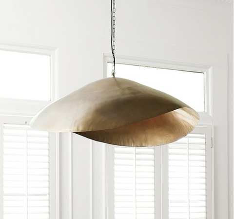 Moira Gold pendant light styled above a dining table, large size