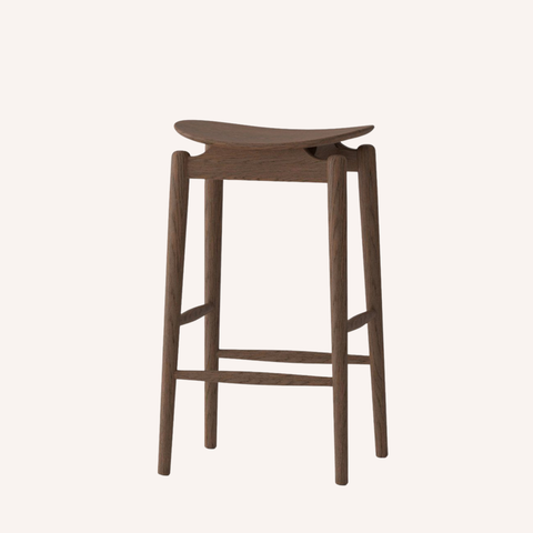 A modern wooden bar stool with a curved seat, four tapered legs, and a footrest, shown against a solid off-white background.