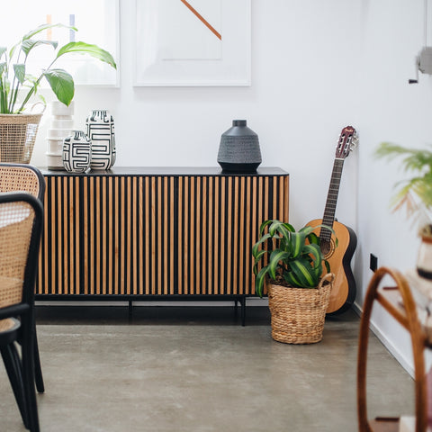 Pete Sideboard Black and Natural two-tone, styled in a dining room