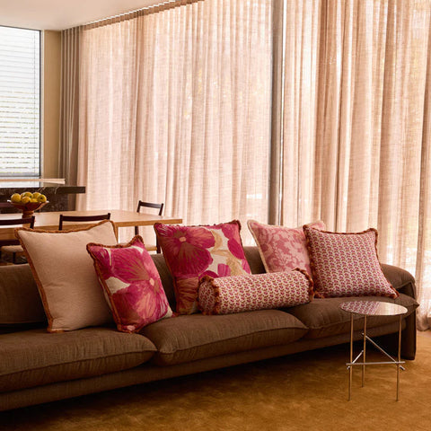 Petit Madeline Pink Linen Cushion styled on a sofa