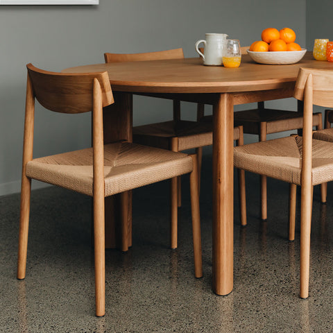 Roland solid oak dining chair with woven rope cord seat, styled in a dining room
