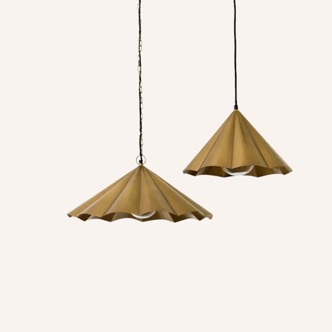 two scalloped gold pendant lights on white background