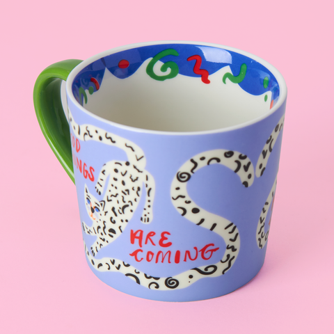 Side view of Good Things Are Coming mug showing pastel design