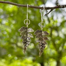 Silver Fern Earrings styled on ear