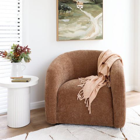 Ted swivel chair in caramel textured polyester, styled in a living room