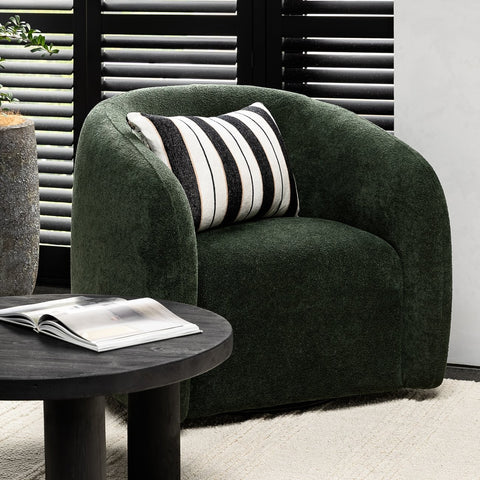 Ted swivel chair in forest green textured polyester, styled in a living room