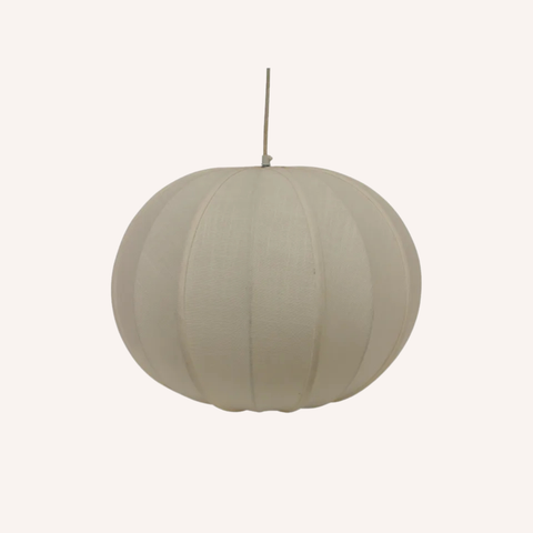 A spherical fabric pendant lamp in a light beige or off-white shade, suspended by a thin cord against a solid off-white background.