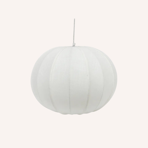 A white fabric pendant light with a ribbed, pumpkin-like shape hanging from a thin cord against a solid off-white background.