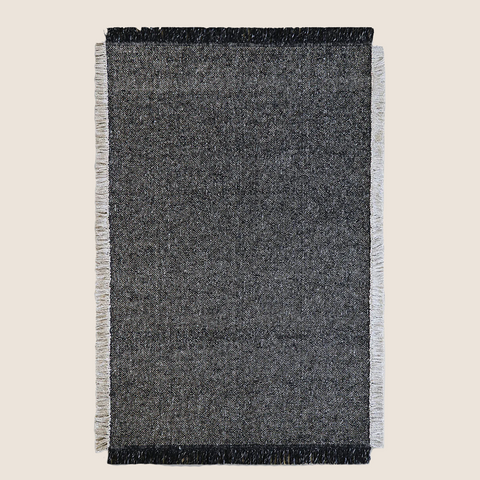 Ulster Black & Natural rug, top view showing tight weave and two-tone fringe