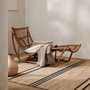 Umbra Rug styled in a room setting, natural jute with black stripe