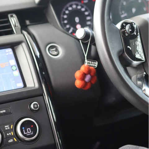 Wild Rose & Blackberry felt flower car air freshener on dashboard