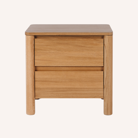 A two-drawer wooden nightstand with a warm oak finish, featuring a square top and blocky legs, shown against a plain off-white background.