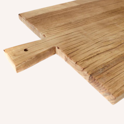 Close-up of sculptural handle on artisan elm serving board