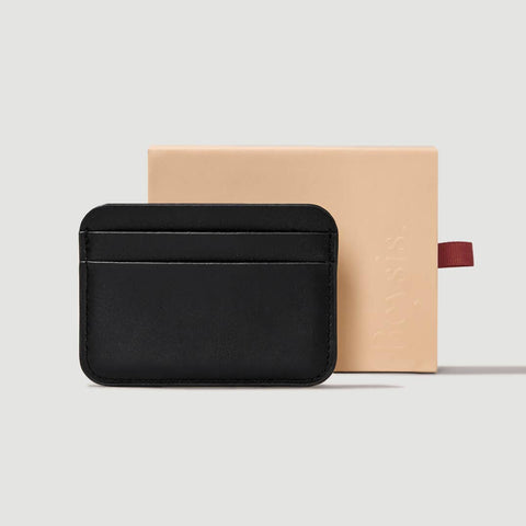 Black leather cardholder with beige box on a light gray background