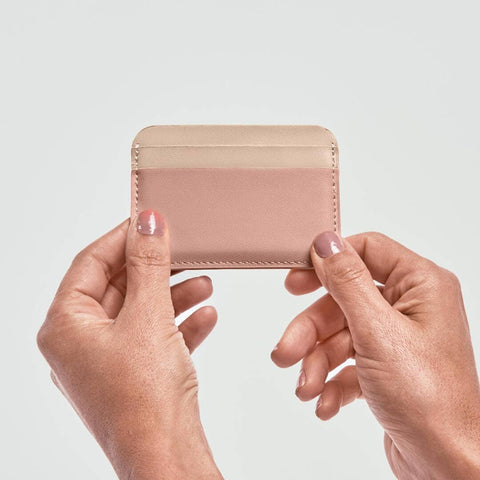 Blush/Sand Card Holder being held in a hand
