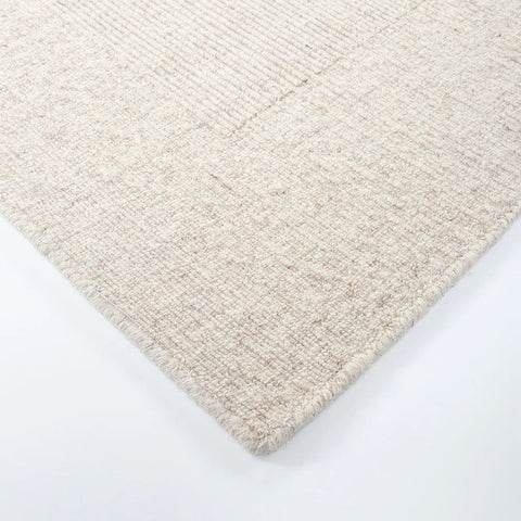 flat weave rug styled under a dining table