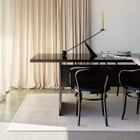 flat weave wool rug in light sand tone, styled in a living room