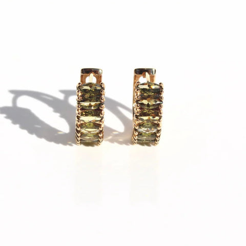 Gold huggie earrings set with peridot-green zirconia stones